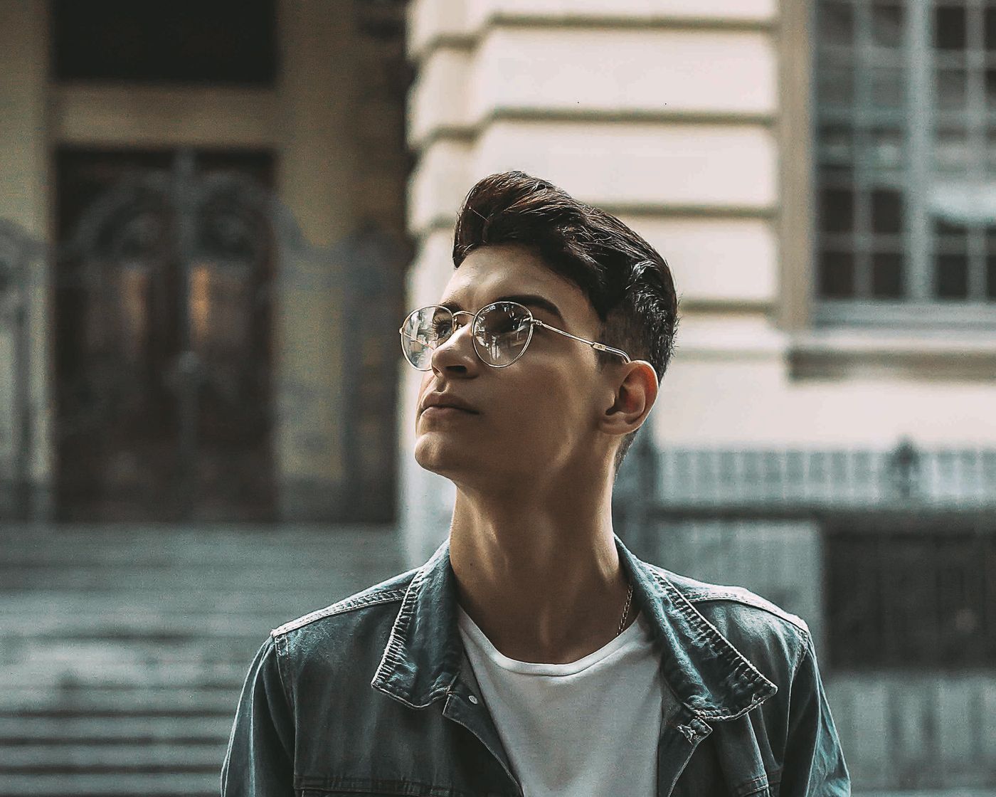 Young man wearing bifocal eyeglasses outdoors